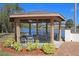 Charming gazebo by the lake featuring ceiling fans, tables, and seating in the Heritage Lake Community at 4831 Wakefield Ct, New Port Richey, FL 34655
