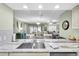 Modern sink with stainless steel features looking into the dining and living area at 4831 Wakefield Ct, New Port Richey, FL 34655