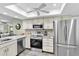 Well-lit kitchen featuring stainless steel appliances, updated cabinets, and granite countertops at 4831 Wakefield Ct, New Port Richey, FL 34655
