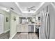 Open kitchen featuring stainless appliances, light-colored cabinets, and an eat-in dining area at 4831 Wakefield Ct, New Port Richey, FL 34655