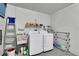 Functional laundry area with washer, dryer, utility sink, and ample storage space at 4831 Wakefield Ct, New Port Richey, FL 34655