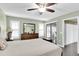 Bedroom with gray flooring, a ceiling fan, shutters and earth tone furniture at 4831 Wakefield Ct, New Port Richey, FL 34655