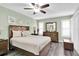 Bedroom with gray flooring, a ceiling fan, shutters and earth tone furniture at 4831 Wakefield Ct, New Port Richey, FL 34655