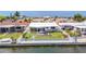 Aerial view of a waterfront home with a well-kept yard, deck, and canal access at 4936 Dory Dr, New Port Richey, FL 34652