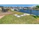 Backyard featuring a patio, lush grass, and access to a canal with boat docks at 4936 Dory Dr, New Port Richey, FL 34652