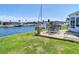 Inviting backyard with a wooden deck and outdoor seating overlooking a canal with boats docked at 4936 Dory Dr, New Port Richey, FL 34652