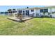 The backyard shows a deck with table and chairs, complemented by well-manicured lawn at 4936 Dory Dr, New Port Richey, FL 34652