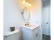 Bright bathroom features modern fixtures, vanity with sleek white countertop and brushed gold faucet at 4936 Dory Dr, New Port Richey, FL 34652