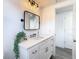 Updated bathroom vanity, black framed mirror, and modern vanity lighting at 4936 Dory Dr, New Port Richey, FL 34652