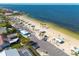 A tranquil beach scene featuring covered picnic areas, palm trees, and parking for convenient access at 4936 Dory Dr, New Port Richey, FL 34652