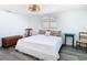 Neutral bedroom featuring wood-look floors, a window, and woven light fixture at 4936 Dory Dr, New Port Richey, FL 34652