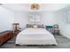 Neutral bedroom with wood-look floors, a window, and woven light fixture at 4936 Dory Dr, New Port Richey, FL 34652