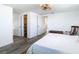 Bedroom featuring neutral walls, wood-look floors, closet, and en-suite bath at 4936 Dory Dr, New Port Richey, FL 34652