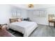 Bright bedroom with wood-look floors, two windows, and woven light fixture at 4936 Dory Dr, New Port Richey, FL 34652