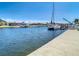 Scenic canal view featuring docked boats, under a blue sky with scattered clouds at 4936 Dory Dr, New Port Richey, FL 34652