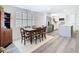 Dining area with wood table, straw chairs, and view of the modern kitchen at 4936 Dory Dr, New Port Richey, FL 34652