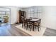 Rustic dining area features a wood table, straw chairs, and a decorative hutch at 4936 Dory Dr, New Port Richey, FL 34652