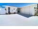 Front exterior of updated waterfront home with a freshly painted driveway, metal roof, and a well-manicured yard at 4936 Dory Dr, New Port Richey, FL 34652
