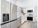 Corner view of kitchen features stainless steel appliances and white cabinets at 4936 Dory Dr, New Port Richey, FL 34652