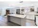 Open kitchen and dining space featuring stainless steel appliances, a large island, and neutral paint at 4936 Dory Dr, New Port Richey, FL 34652