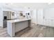 Expansive kitchen with stainless steel appliances, island, and gray wood flooring at 4936 Dory Dr, New Port Richey, FL 34652