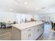 Modern kitchen with stainless steel appliances, white cabinets, quartz countertop, and a sleek microwave and range at 4936 Dory Dr, New Port Richey, FL 34652