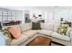 Spacious living room featuring an L-shaped couch, wooden coffee table, and view to the kitchen and dining area at 4936 Dory Dr, New Port Richey, FL 34652