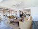 Sunroom featuring wicker furniture, water views and open access to dining and kitchen at 4936 Dory Dr, New Port Richey, FL 34652