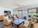 Bright sunroom with wicker furniture, water views, and a mounted television at 4936 Dory Dr, New Port Richey, FL 34652