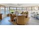 The waterfront sunroom is brightly lit with wicker furnishings and water views at 4936 Dory Dr, New Port Richey, FL 34652