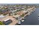 Scenic aerial view showcasing waterfront homes with private boat docks and access to open water at 5000 Southshore Dr, New Port Richey, FL 34652
