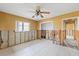 Bedroom featuring tile flooring and framing for renovation, plus natural light from large windows at 5000 Southshore Dr, New Port Richey, FL 34652