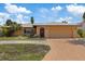 Charming home with a well-maintained lawn, mature palm trees, and an attached two-car garage at 5000 Southshore Dr, New Port Richey, FL 34652