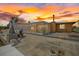 Waterfront home's exterior featuring a boat lift and screened outdoor space at sunset at 5000 Southshore Dr, New Port Richey, FL 34652