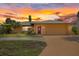 Charming home with a well-maintained lawn, mature palm trees, and an attached two-car garage at 5000 Southshore Dr, New Port Richey, FL 34652