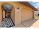 Charming home exterior featuring a stucco archway, decorative tile, and a two-car garage at 5000 Southshore Dr, New Port Richey, FL 34652