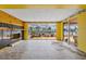 Waterfront lanai featuring a fireplace, tile flooring, and sliding glass doors to outdoor patio at 5000 Southshore Dr, New Port Richey, FL 34652