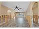 Bright living area with tile flooring, ceiling fan, and framing for renovation with natural light at 5000 Southshore Dr, New Port Richey, FL 34652