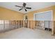 Spacious living room featuring tile flooring, ceiling fan, and under construction bathroom area at 5000 Southshore Dr, New Port Richey, FL 34652