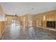 Open-concept living room shows tile flooring, exposed framing and archways for custom design at 5000 Southshore Dr, New Port Richey, FL 34652