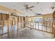 Open living area with tile floors, modern ceiling fans, and wall and plumbing under construction at 5000 Southshore Dr, New Port Richey, FL 34652