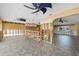 Open living area with tile floors, modern ceiling fans, and wall and plumbing under construction at 5000 Southshore Dr, New Port Richey, FL 34652