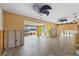 Open living area with tile floors, modern ceiling fans, and views to outdoor lanai and waterfront at 5000 Southshore Dr, New Port Richey, FL 34652