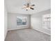 Spacious bedroom with carpet flooring, ceiling fan, and windows at 553 52Nd N Ave, St Petersburg, FL 33703