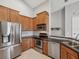 Kitchen with stainless steel appliances, black granite countertops, and wood cabinets at 553 52Nd N Ave, St Petersburg, FL 33703