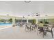 Covered outdoor seating area with tables and ceiling fans next to community pool at 553 52Nd N Ave, St Petersburg, FL 33703