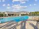 Community pool with pool house and tanning deck with space for residents to relax by the poolside at 553 52Nd N Ave, St Petersburg, FL 33703