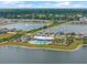 Aerial view of the community pool and amenity center surrounded by lakes and beautiful homes at 582 8Th Nw St, Ruskin, FL 33570
