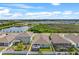 A scenic aerial view of the property, showcasing the home, backyard, and nearby lake and neighborhood at 582 8Th Nw St, Ruskin, FL 33570