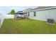A beautiful backyard featuring a well-maintained lawn and a cozy gazebo seating area at 582 8Th Nw St, Ruskin, FL 33570